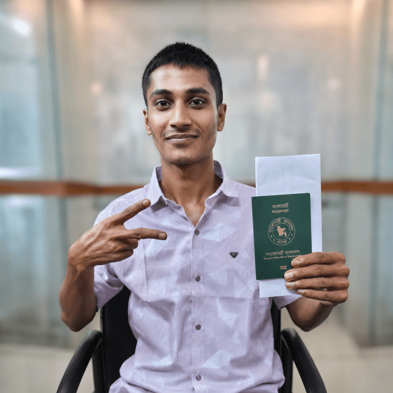 CV Felow client holding an approved passport and visa letter towards the camera