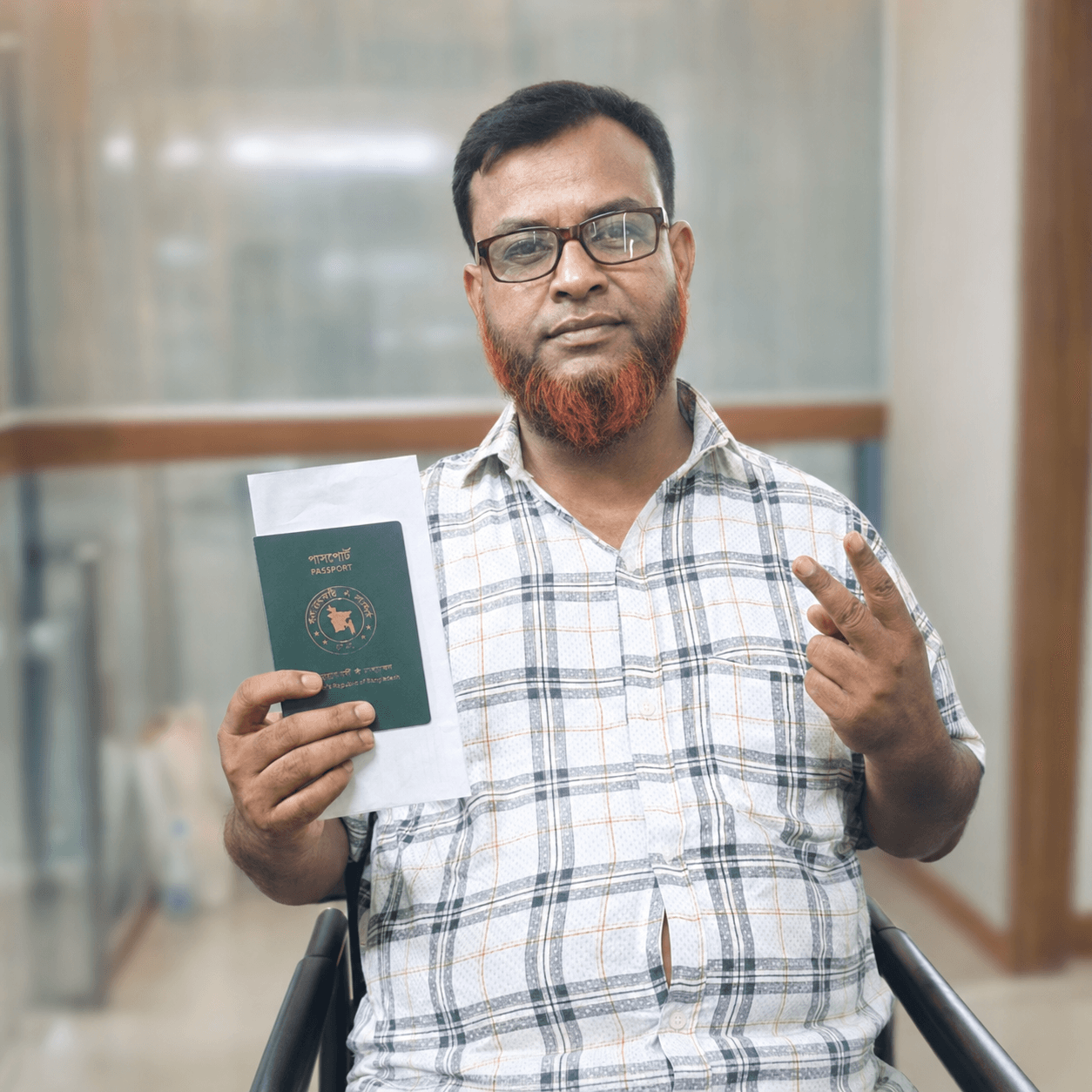 CV Felow client seated, holding an approved passport after a residence application